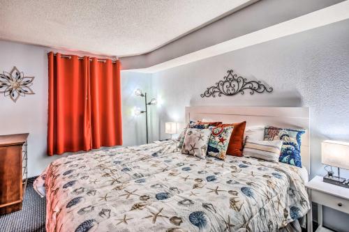 a bedroom with a large bed and red curtains at Oceanfront N Myrtle Beach Condo with Hot Tub! in Myrtle Beach