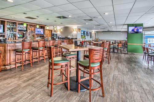 a bar with wooden stools in a restaurant at Balcony and Beach View! Remodeled N Myrtle Beach Gem in Myrtle Beach