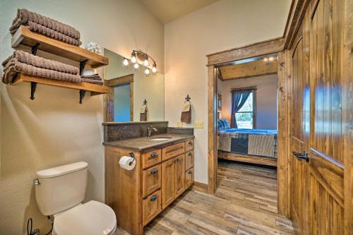 a bathroom with a toilet and a sink at Ouachita Mtn Home Near ATV and Hiking Trails! in Big Cedar