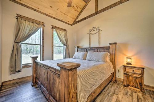 a bedroom with a wooden bed and a window at Ouachita Mtn Home Near ATV and Hiking Trails! in Big Cedar