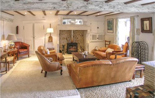 a living room with leather furniture and a fireplace at Amazing Home In Suaux in Chichiat