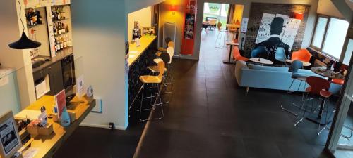 a room with a counter and chairs in a store at ibis Moulins in Moulins
