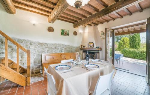 a dining room with a table with white table cloth at Holiday Home Loc Borgacciano in Monterchi
