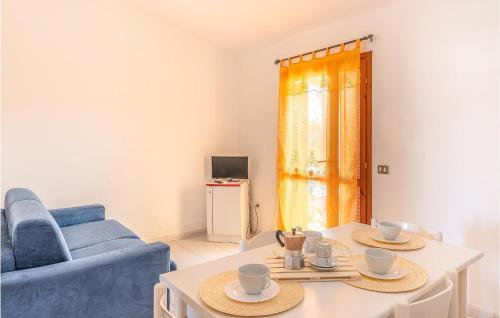 a living room with a blue couch and a table at Trilo 6 in San Teodoro