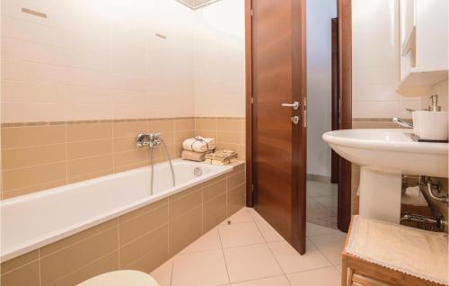 a bathroom with a bath tub and a sink at Casa Virgilio in Viareggio