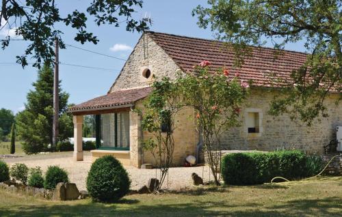 a small stone house with a red roof at Amazing Home In Gindou in Gindou