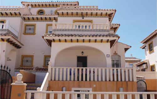 a large white house with a white balcony at 2 Bedroom Lovely Home In Orihuela Costa in Orihuela Costa