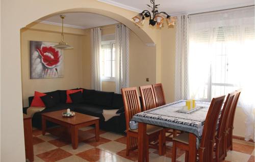 a living room with a table and a couch at 2 Bedroom Lovely Home In Orihuela Costa in Orihuela Costa