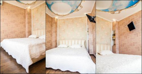 two pictures of a bedroom with two beds at Luxury Apartment in the City Centre in Odesa