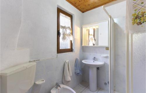 a white bathroom with a sink and a toilet at Stunning Apartment In Bagni Di Lucca Lu With 1 Bedrooms in Cocciglia