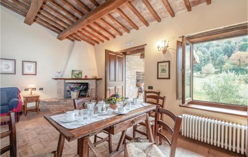 a dining room with a table and chairs and a fireplace at Casalino in Bazzano di Spoleto