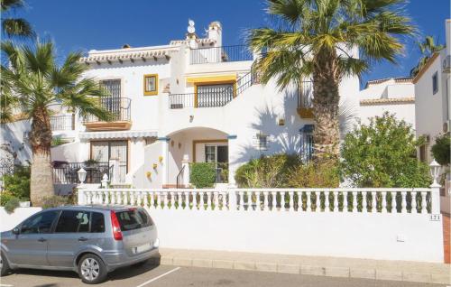 a car parked in front of a white house at Amazing Apartment In Orihuela With Wifi in Los Dolses