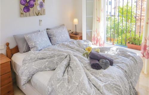 a bedroom with a bed with a flower on it at Awesome Apartment In Orihuela With Kitchen in Los Dolses
