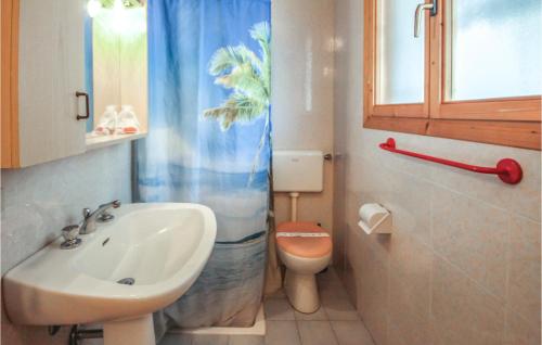 a bathroom with a sink and a toilet and a shower curtain at Felix 3 in Lido di Scacchi