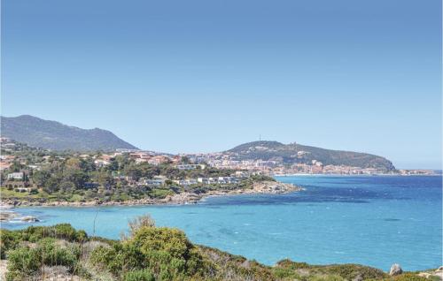 a view of a bay with houses and the ocean at 2 Bedroom Cozy Apartment In Algajola in Algajola
