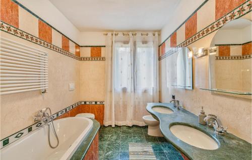 y baño con bañera y lavamanos. en Villa Valle Doro, en Selvatelle