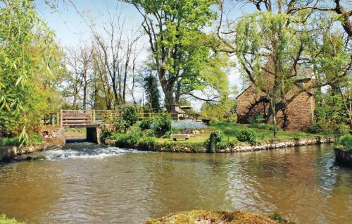 a bridge over a river in a park at 2 Bedroom Nice Home In La Gacilly in La Gacilly