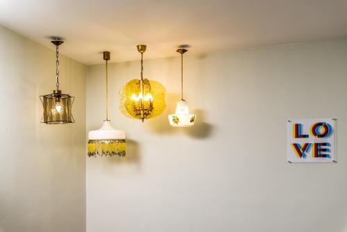a room with three lights hanging from a wall at Ios Resort in Ios Chora