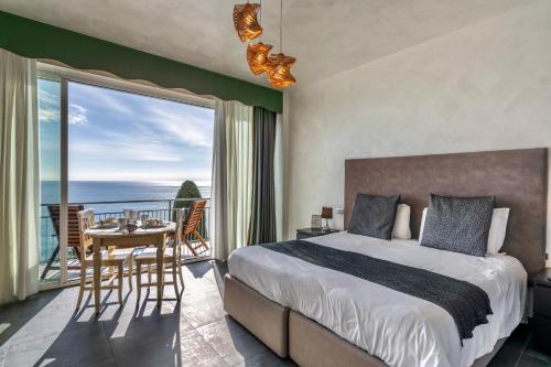 a bedroom with a bed and a view of the ocean at Baba Residences in Alassio