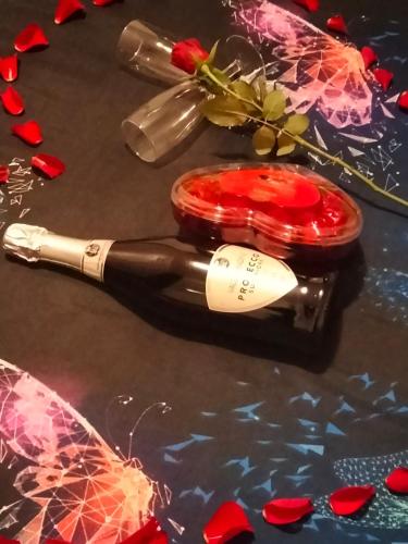 a bottle of wine sitting on a table with hearts at Hermes Complex 2 Paralimni Cyprus in Paralimni