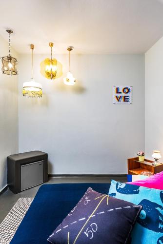 a bedroom with a bed and a table and lights at Ios Resort in Ios Chora