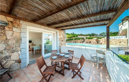 a patio with a table and chairs and a swimming pool at Trilo 6 in Baja Sardinia