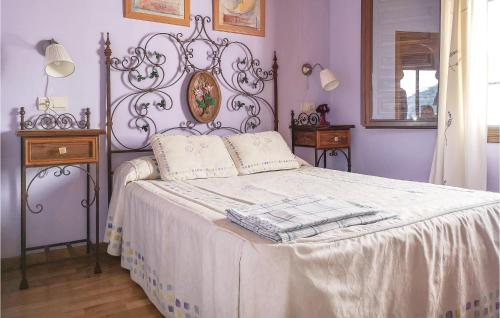 a bedroom with a bed with a white bedspread at Cozy Home In Benalaura With House A Mountain View in Benalauría