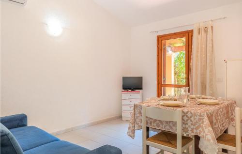 a dining room with a table and a tv at Trilo 6 in San Teodoro