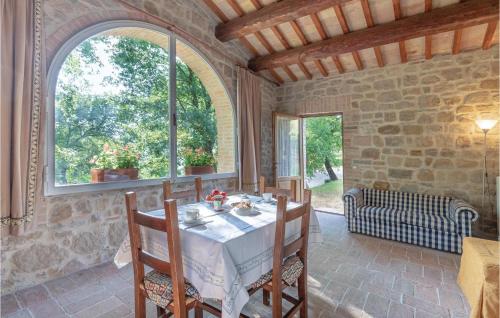 a dining room with a table and a window at Gioiara in Valfabbrica