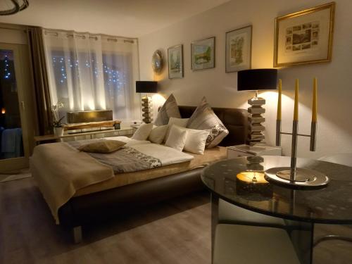 a living room with a bed and a table at Appartement Herrlich in Bad Wildbad