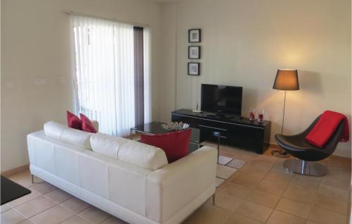 a living room with a white couch and a television at 2 Bedroom Cozy Home In Ciudad Quesada in Ciudad Quesada