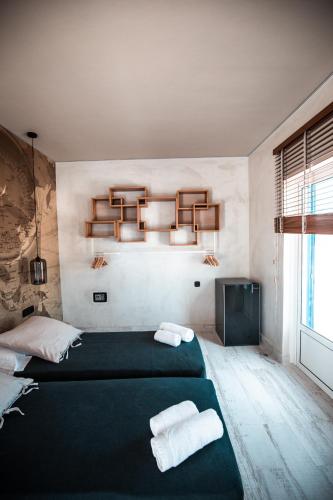 a bedroom with a green bed with towels on it at Ios Resort in Ios Chora