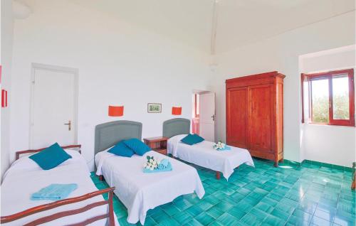 トルヴァイアニカにあるCastello Sulla Spiaggiaのベッド2台と冷蔵庫が備わる客室です。