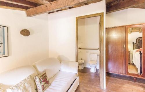 a living room with a white couch and a toilet at Casa Matilde in Comano