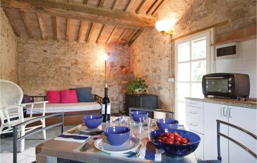 a kitchen with a table with a bowl of tomatoes on it at Poggialino in Sasso Pisano