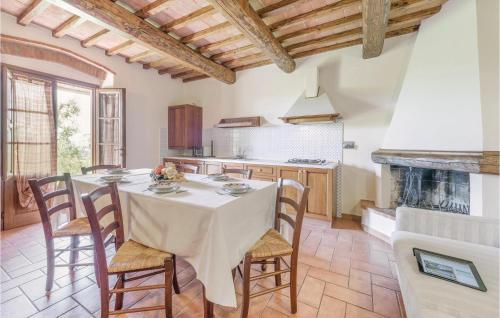 a kitchen with a table with chairs and a fireplace at Leccino in Lamporecchio