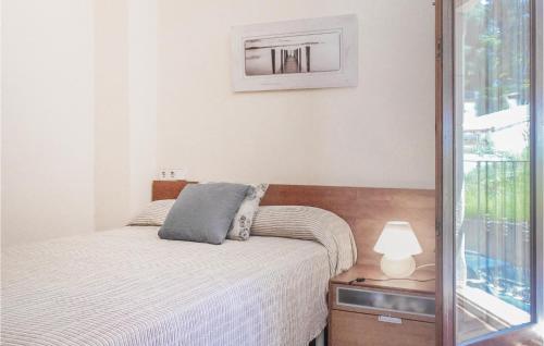 a small bedroom with a bed and a mirror at Beautiful Home In Tossa De Mar With 4 Bedrooms, Wifi And Swimming Pool in Tossa de Mar