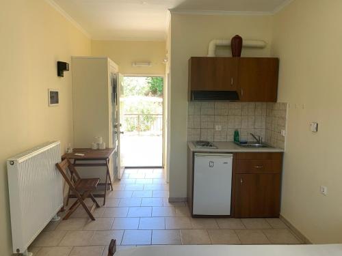 a kitchen with a sink and a table in it at Despina Studios Raxes Ikaria # 1 in Raches