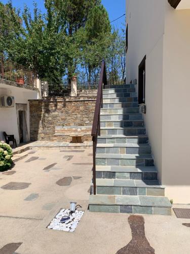 a set of stairs leading up to a building at Despina Studios Raxes Ikaria # 1 in Raches