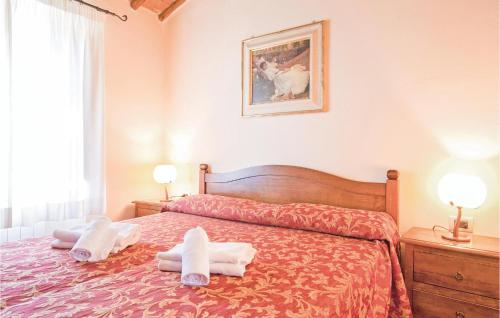 a bedroom with a bed with towels on it at Sangiovese 5 in San Donato in Poggio