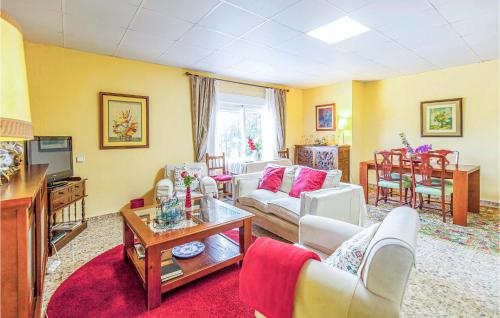 a living room with a couch and a table at Lovely Home In Tomares With Kitchen in Tomares
