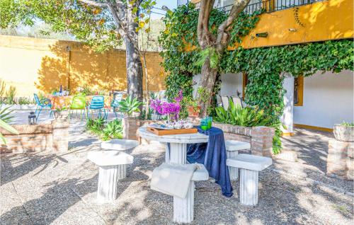 a table with chairs and a table with a blue table cloth at Lovely Home In Tomares With Kitchen in Tomares