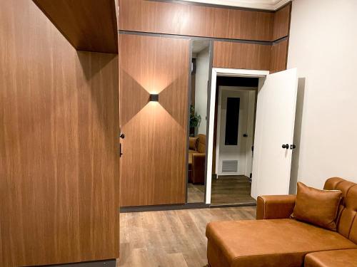 a living room with a couch and a mirror at Whytescape Serviced Apartments in Abuja