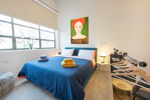 a bedroom with a bed with a blue blanket at Loft 19 in Turin