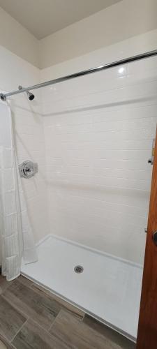 a bathroom with a shower with a white tub at Americas Best Value Inn San Antonio Downtown Riverwalk in San Antonio