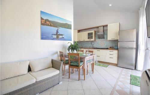 a kitchen and dining room with a couch and a table at Splendido Appartamento in Santa Maria di Castellabate