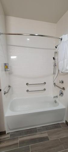 a white bath tub in a bathroom with towels at Americas Best Value Inn San Antonio Downtown Riverwalk in San Antonio