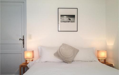 um quarto com uma cama com lençóis brancos e 2 candeeiros em Cozy Apartment In Bonnieux With Kitchen em Bonnieux