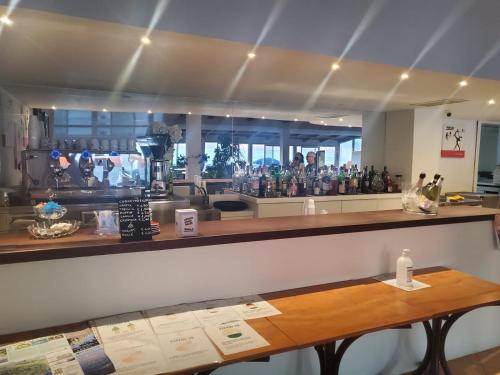 a bar with a counter with many bottles of wine at Hotel Residence La Darsena in Agropoli