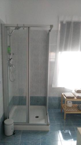 a shower with a glass door in a bathroom at Corte Disore in Rivolto